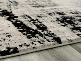 Warmstead Furniture - Ashley Furniture - Zekeman Rug - 5'3" x 7'7" Rug / Black/Cream/Gray - R404922