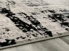 Warmstead Furniture - Ashley Furniture - Zekeman Rug - 5'3" x 7'7" Rug / Black/Cream/Gray - R404922