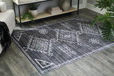 Warmstead Furniture - Ashley Furniture - Arloman Rug - 5' x 7' Washable Rug / Black/Cream/Gray - R405932
