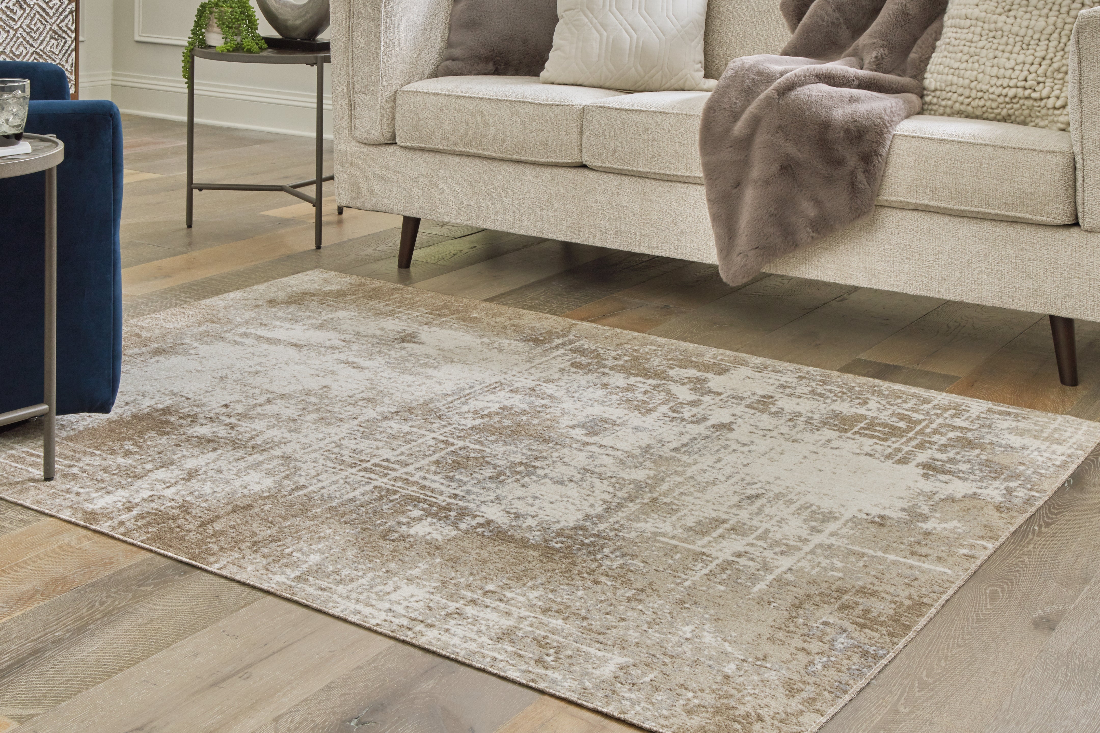 Warmstead Furniture - Ashley Furniture - Grifflain Rug - 7'10" x 10'3" Washable Rug / Tan/Brown/Gray - R406231
