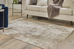 Warmstead Furniture - Ashley Furniture - Grifflain Rug - 7'10" x 10'3" Washable Rug / Tan/Brown/Gray - R406231
