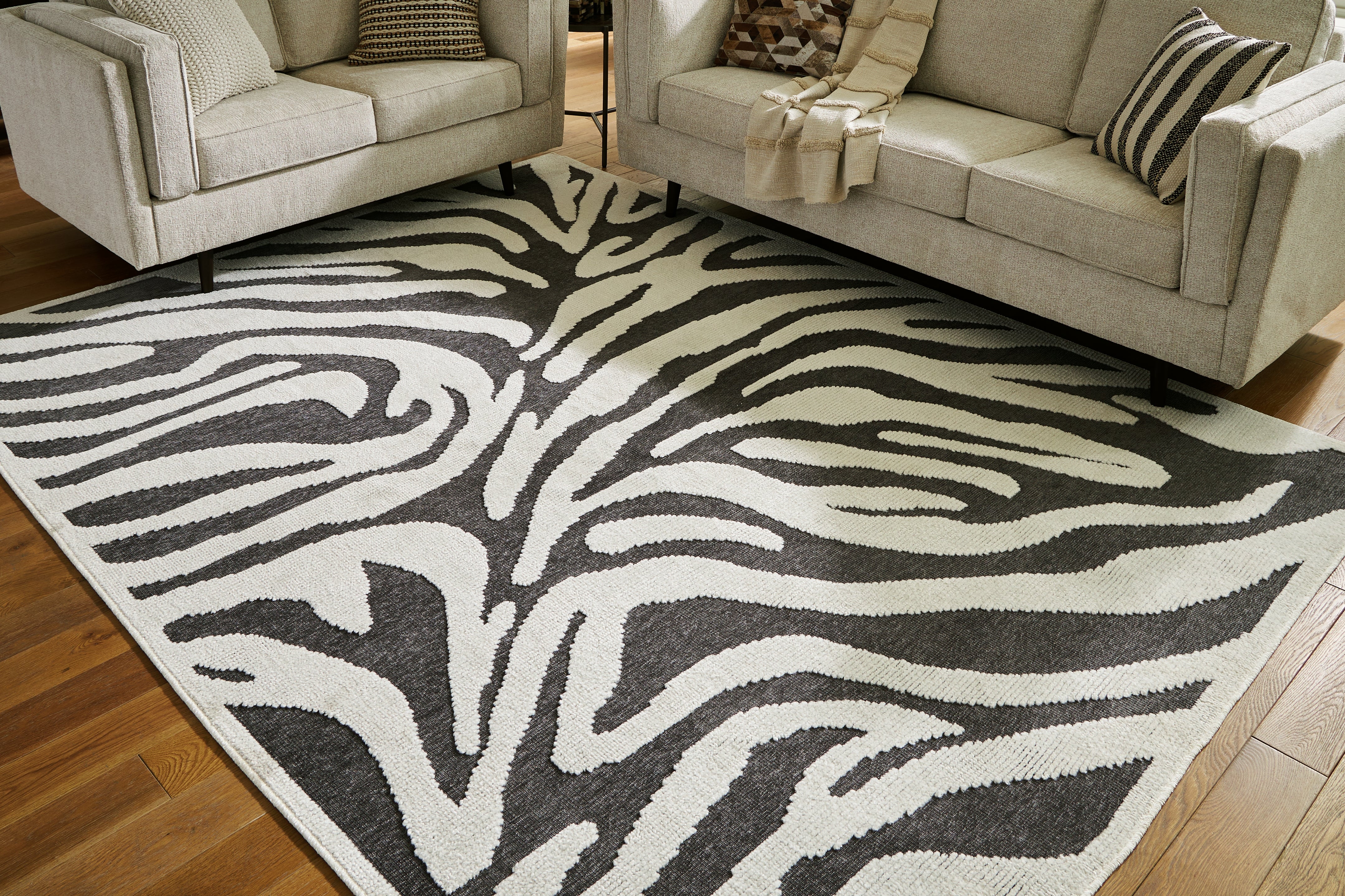 Warmstead Furniture - Ashley Furniture - Thomwith Rug - 8' x 10'2" Washable Rug / Black/Ivory - R406291