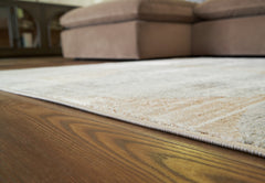 Warmstead Furniture - Ashley Furniture - Truward Rug - 5' x 7' Rug / Linen/Gray/Caramel - R406472