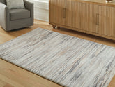 Warmstead Furniture - Ashley Furniture - Nace Rug - 7'6" x 9'6" Area Rug / Gray/Brown/White - R407471