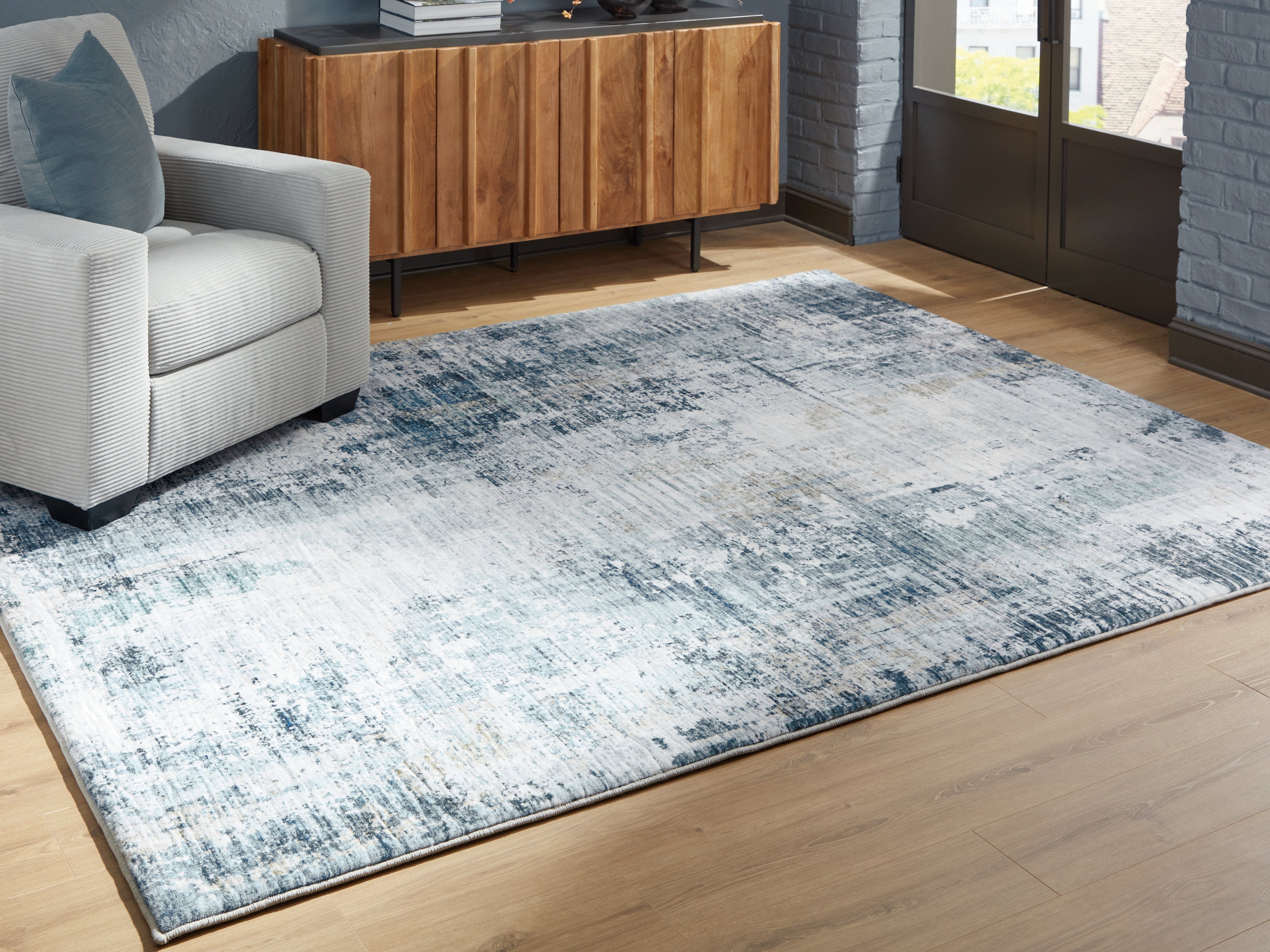 Warmstead Furniture - Ashley Furniture - Arlenmont Rug - 5' x 7' Area Rug / Blue/White/Brown - R407482