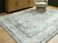 Warmstead Furniture - Ashley Furniture - Ladstoney Rug - 5' x 7' Area Rug / Teal/Beige/Ochre - R407502