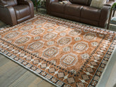 Warmstead Furniture - Ashley Furniture - Qaabiz Rug - 5' x 7' Area Rug / Sienna/Ivory/Black - R407522