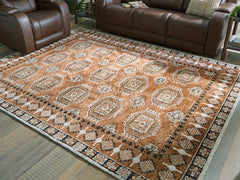 Warmstead Furniture - Ashley Furniture - Qaabiz Rug - 5' x 7' Area Rug / Sienna/Ivory/Black - R407522