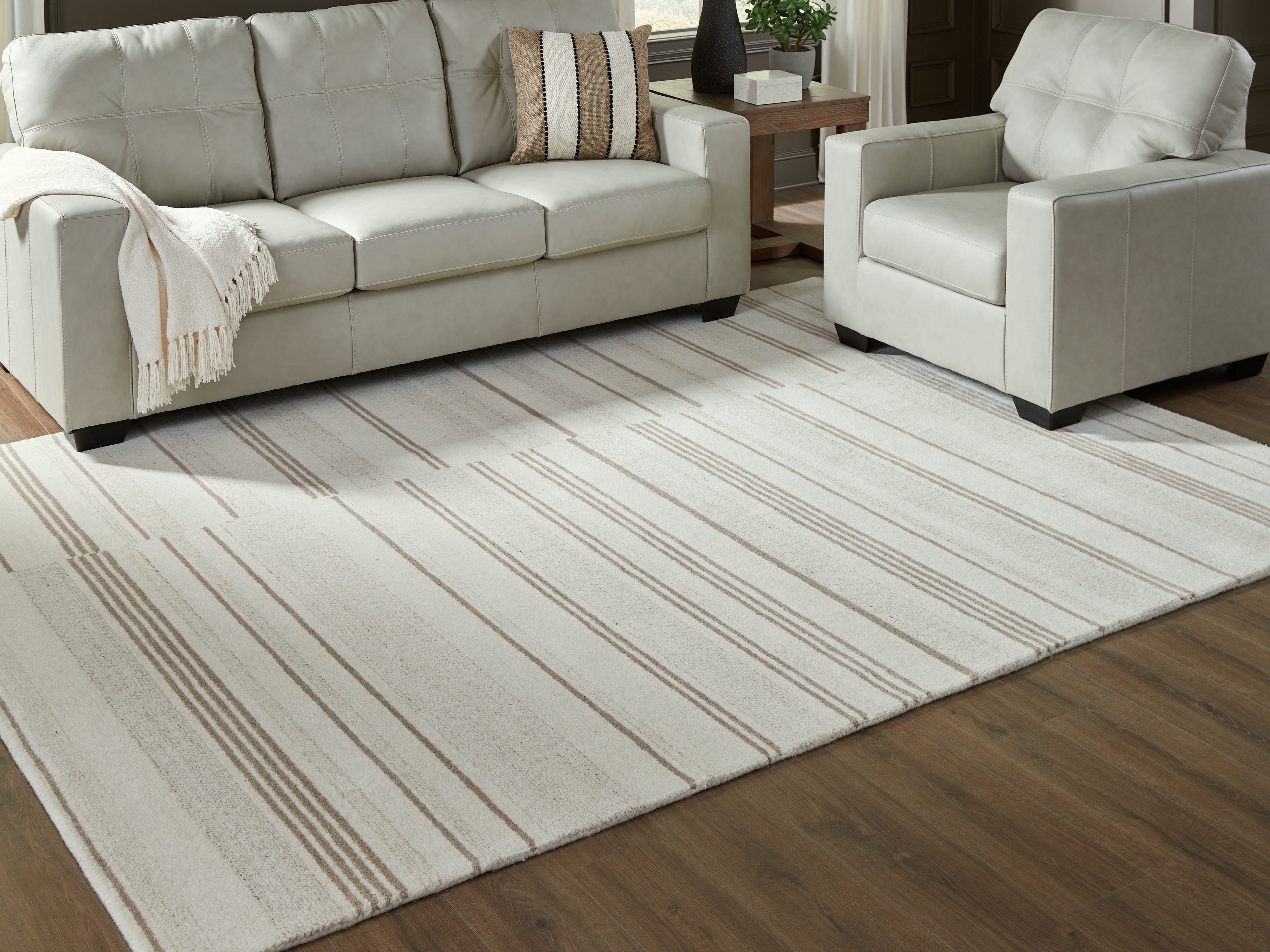 Warmstead Furniture - Ashley Furniture - Gadence Rug - 7'8" x 10' Area Rug / Ivory/Tan - R407641