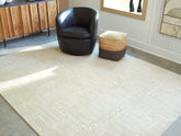 Warmstead Furniture - Ashley Furniture - Wolbert Rug - 5' x 7' Area Rug / Tan/Ivory - R407662