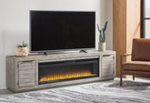 Warmstead Furniture - Ashley Furniture - Naydell 92" TV Stand with Electric Fireplace - 92" TV Stand with Electric Fireplace / Gray - W996W1