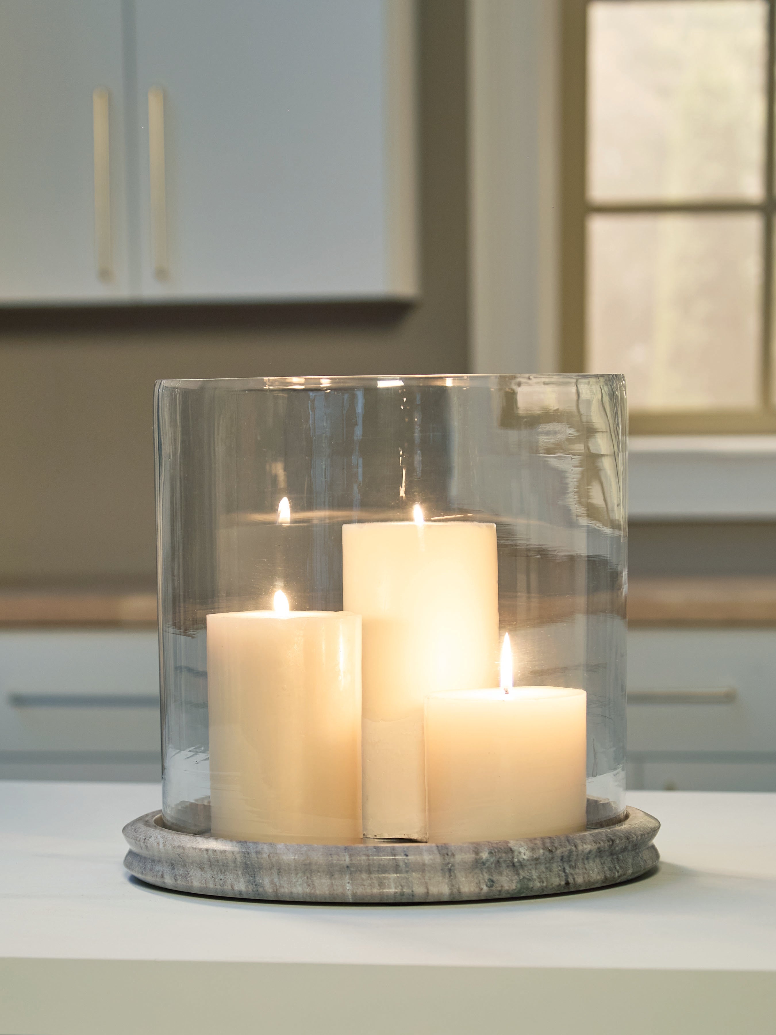 Warmstead Furniture - Ashley Furniture - Saskia Candle Holder - Candle Holder / Clear/Beige - A2000847