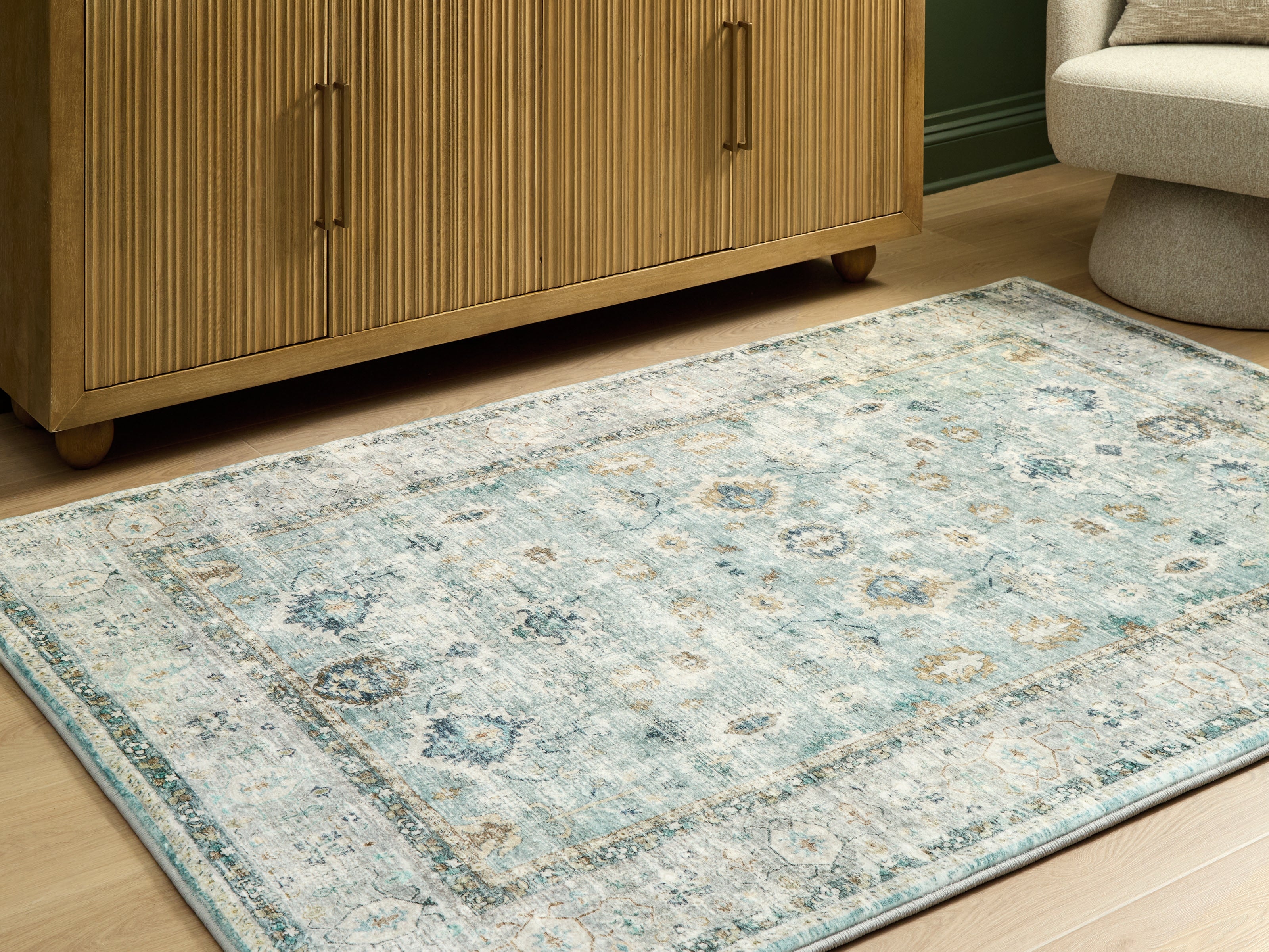 Warmstead Furniture - Ashley Furniture - Ladstoney Rug - 5' x 7' Area Rug / Teal/Beige/Ochre - R407502