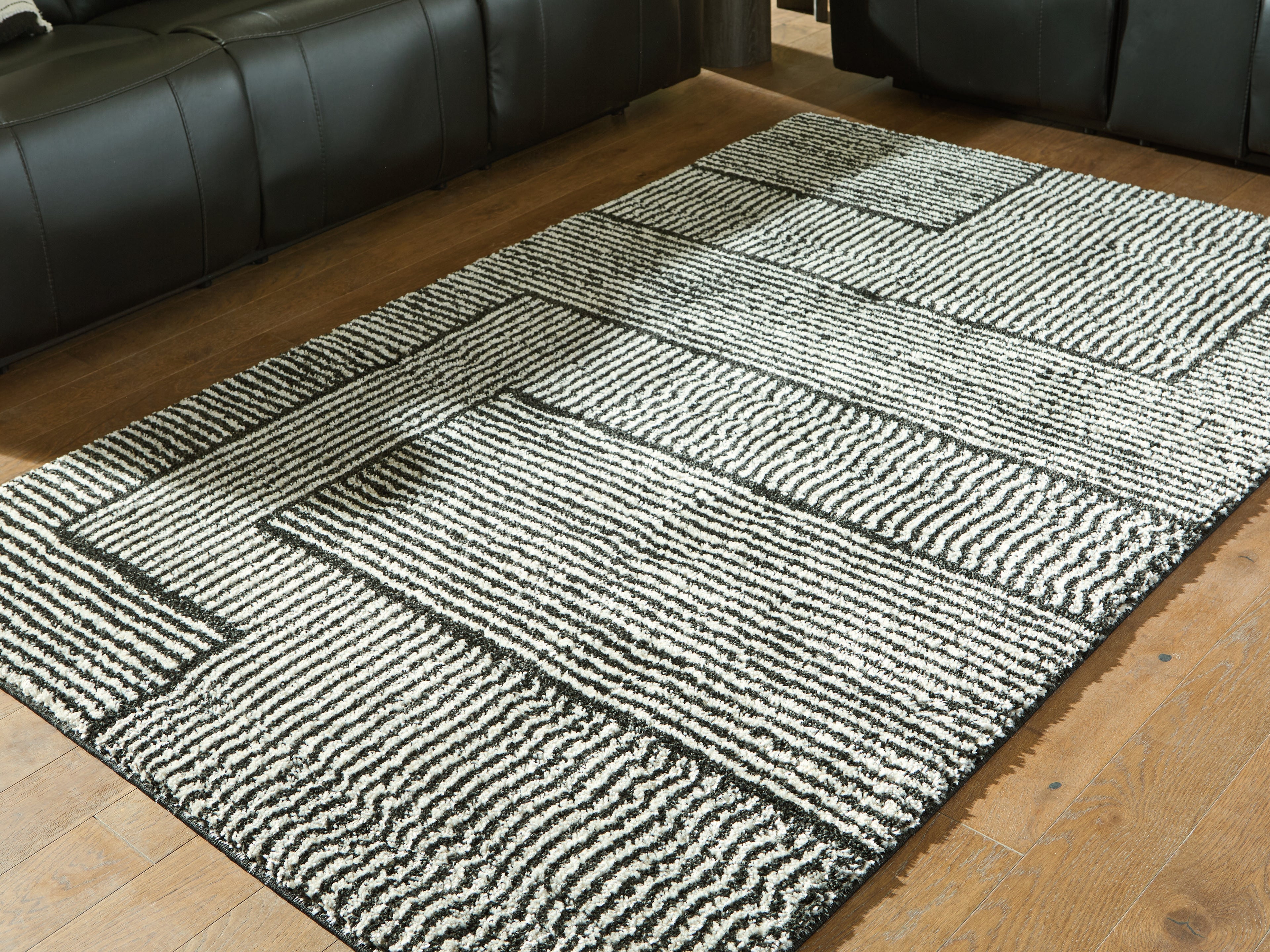Warmstead Furniture - Ashley Furniture - Kurtmen Rug - 5' x 7' Area Rug / Black/Ivory - R407592