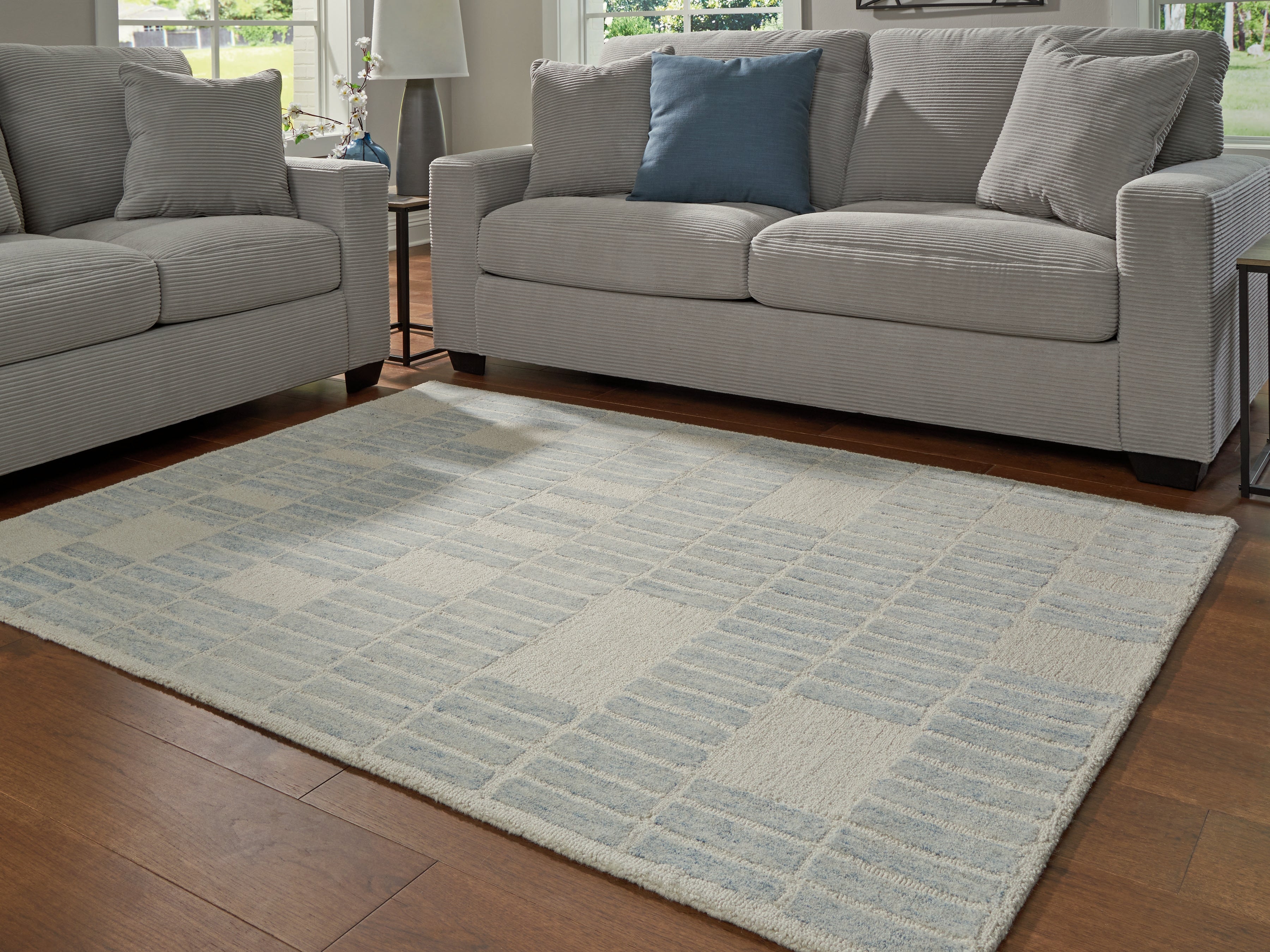 Warmstead Furniture - Ashley Furniture - Dylanton Rug - 5' x 7' Area Rug / Ivory/Blue - R407812